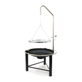 Outdoor cooking setup with a black grill and hanging pan on a white background