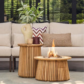 Wooden fire pit table with flames in a patio setting with a sofa and decorative pillows.