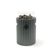 Gray table top burner with glass top holding rocks on a white background