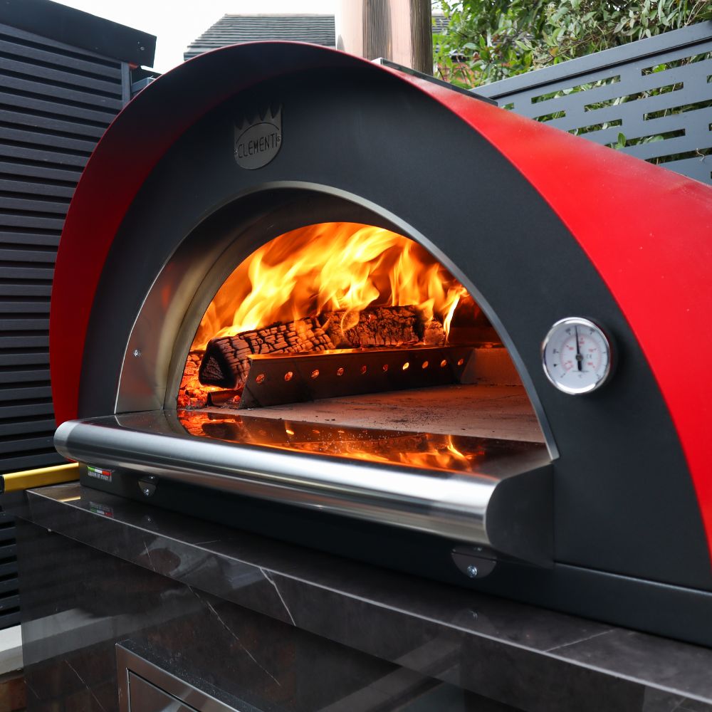 Red and black outdoor pizza oven with wood burning inside