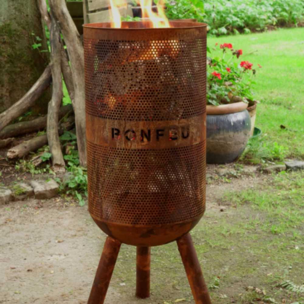 Rust-colored metal fire pit with 'PONFOL' branding in a garden setting.