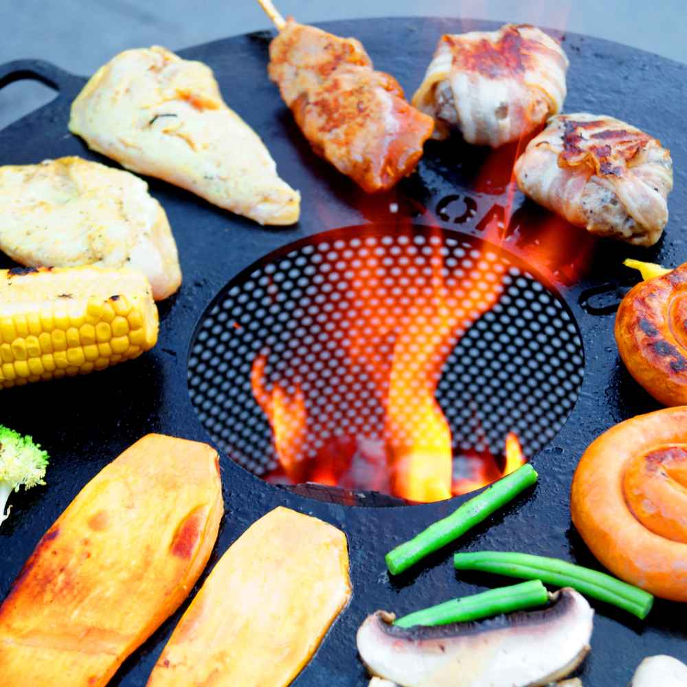 Grilled food items on a barbecue grill with visible flames.