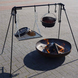 Outdoor fire pit with cooking equipment on a metal stand