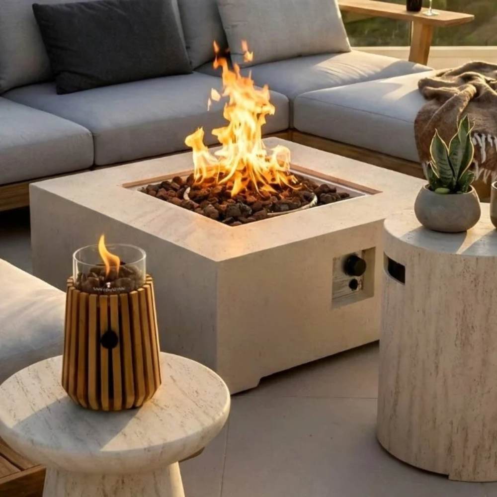 Outdoor setting with a fire pit table, decorative candle, and potted plant.