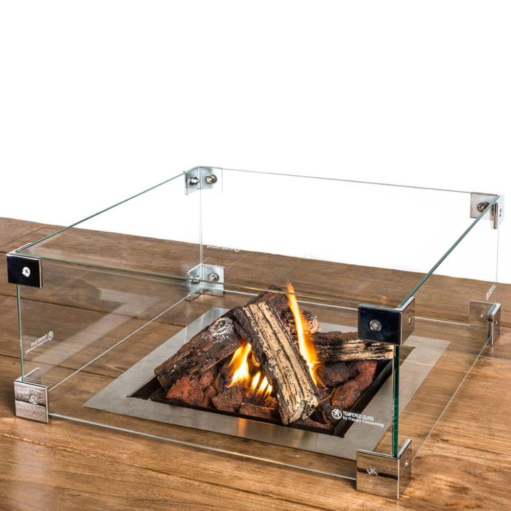 Square Glass set for Fire Pit Table with burning logs on a wooden surface