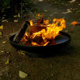 Fire pit with flames burning in an outdoor setting