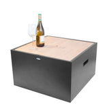 Gray cube-shaped outdoor table with a bottle and glass on a white background