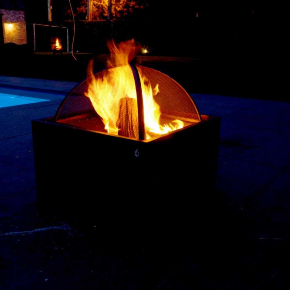 Fire pit with flames glowing brightly at night