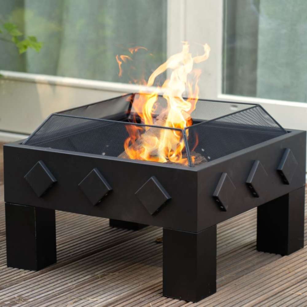 Black outdoor fire pit with flames on a wooden deck