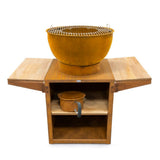 Wooden barbecue grill with a bowl on top and shelves below on a white background