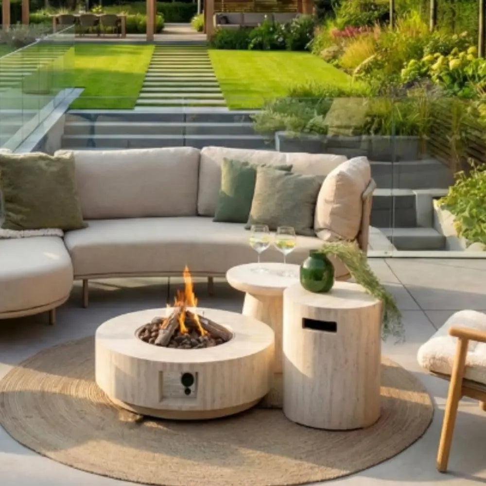 Outdoor patio with a fire pit table, seating area, and garden.