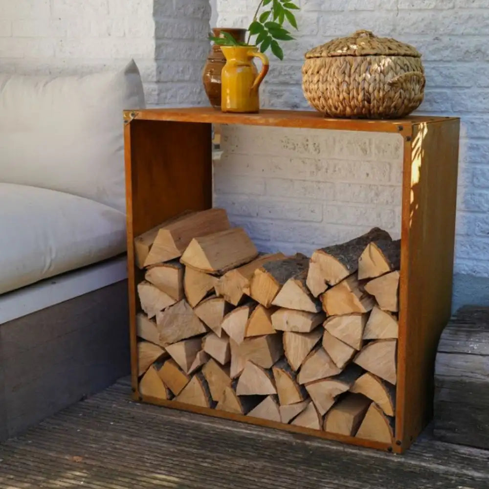 Wooden firewood storage unit with stacked logs against a white brick wall.
