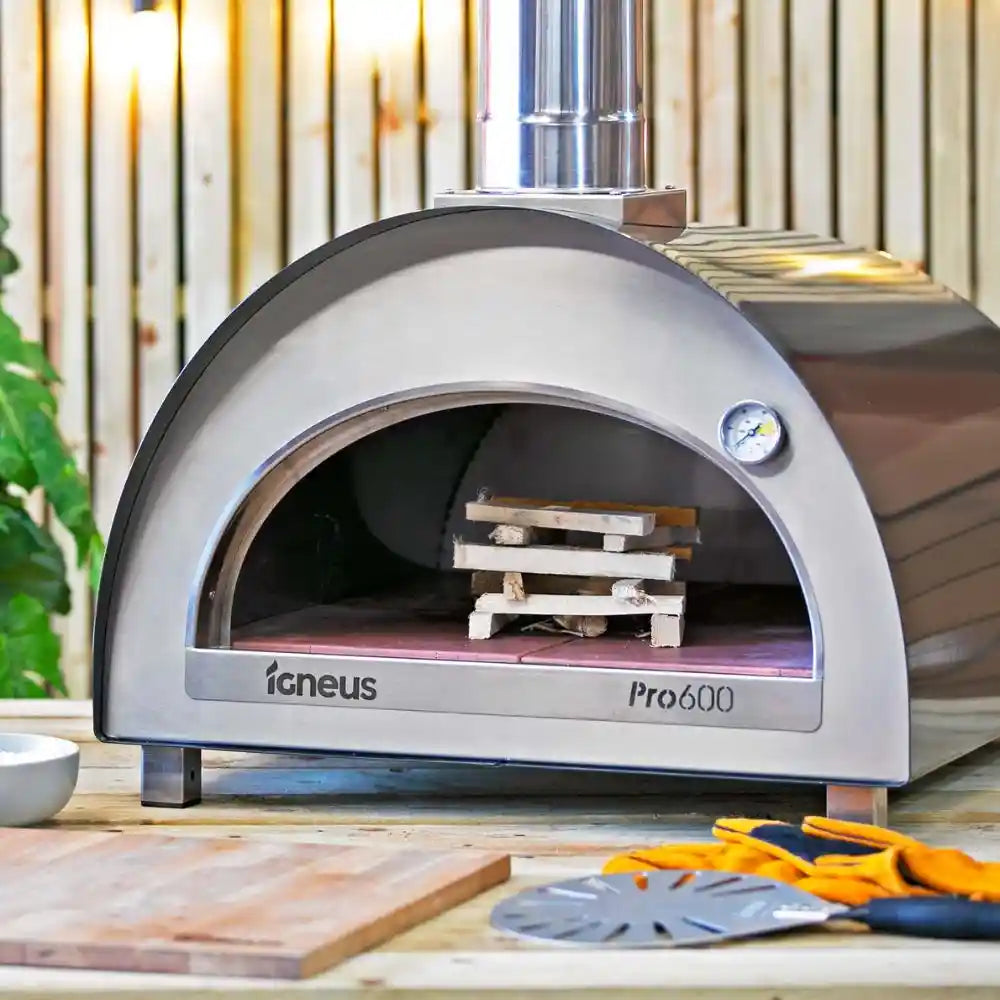 Outdoor pizza oven with 'Igneus Pro600' branding on a wooden surface.