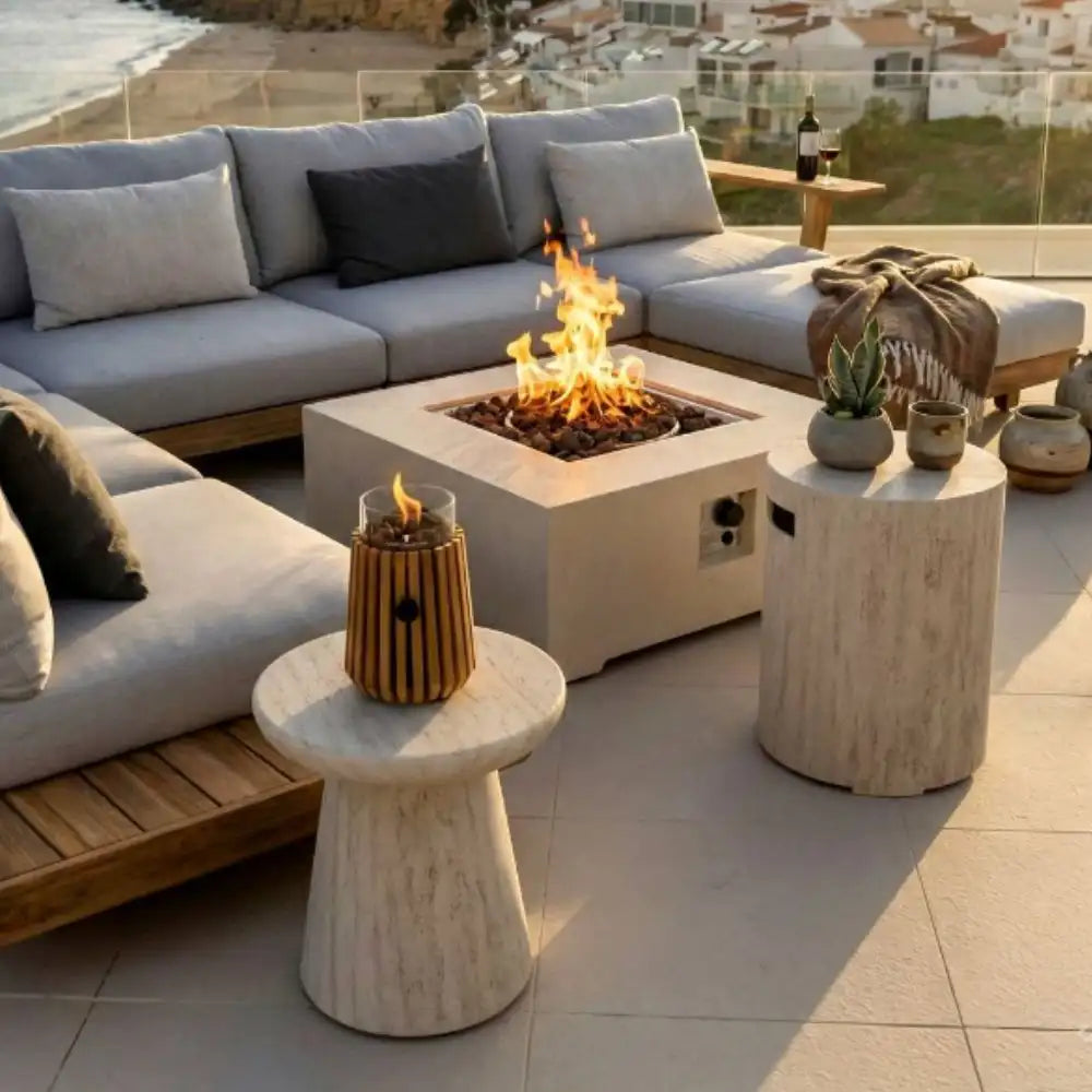 Outdoor patio with fire pit, Table Top Burner, seating area, and decorative elements on a sunny day.