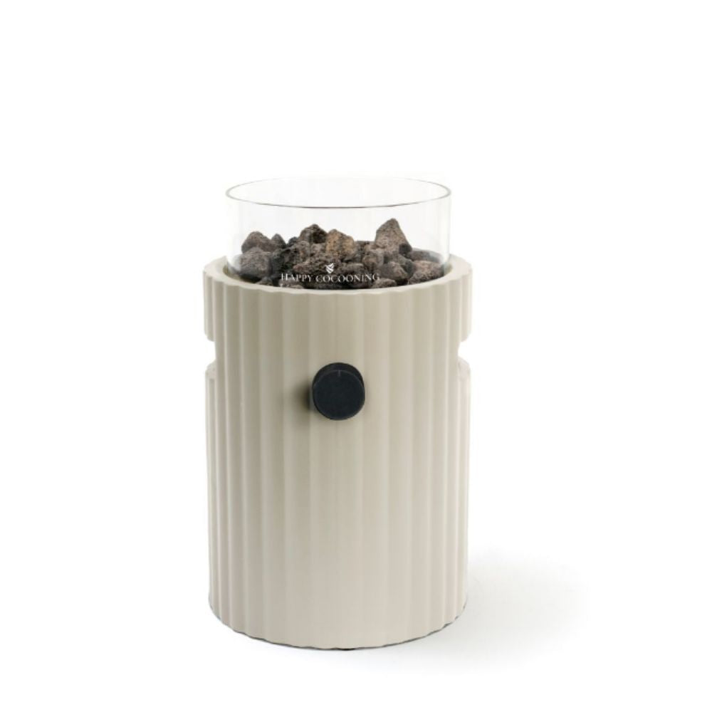 table top burner with glass top holding rocks on a white background