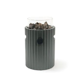Gray table top burner with glass top holding rocks on a white background