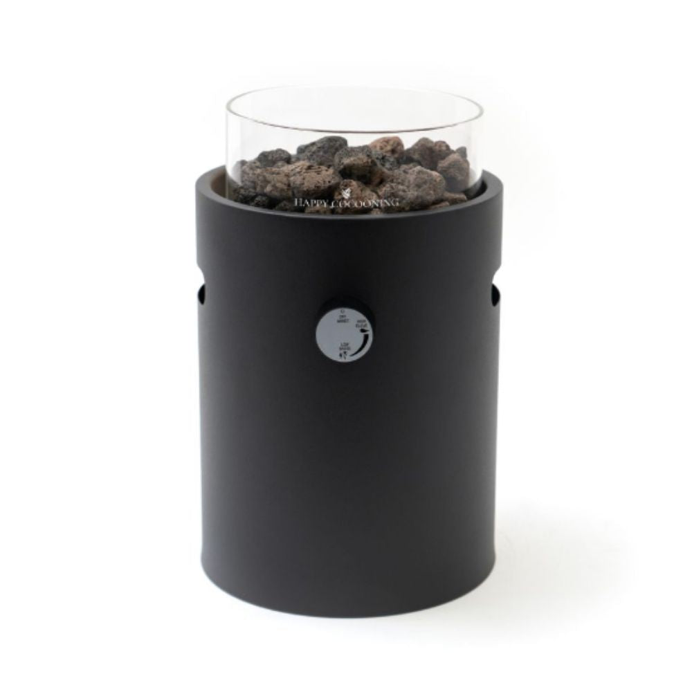 Black cylindrical table top burner with glass cover and rocks on a white background