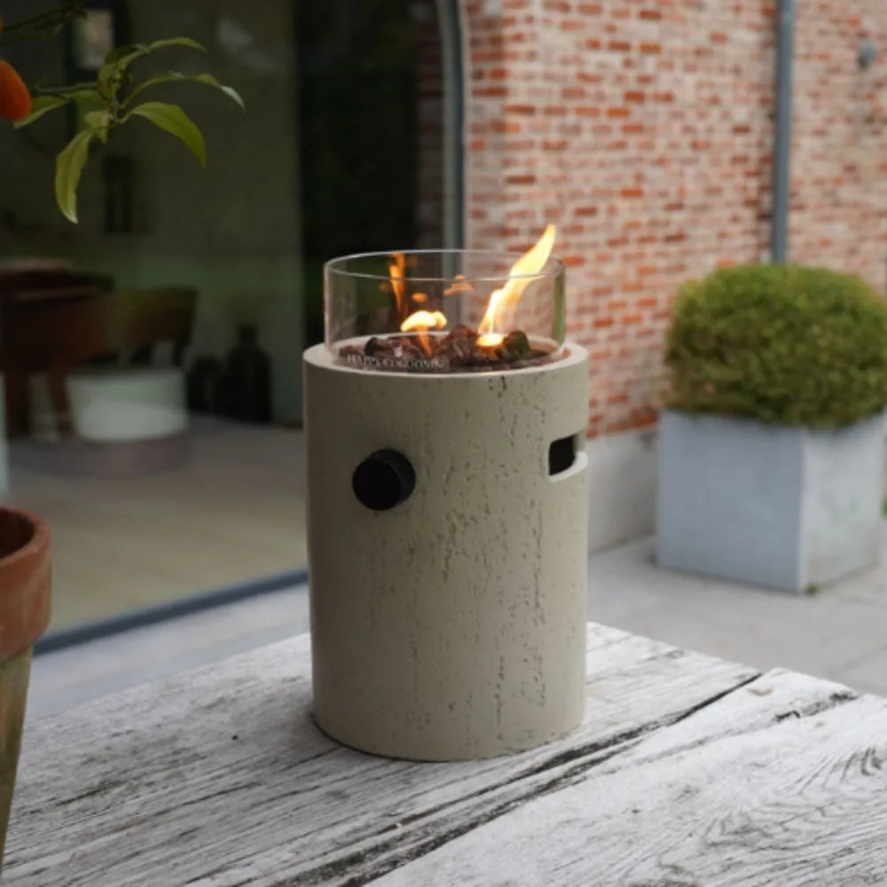 Cylindrical Table Top Burner with flames on a wooden surface.