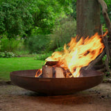 Fire pit with flames burning in a garden setting