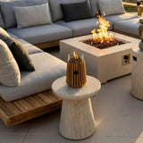 Outdoor patio with sectional sofa, fire pit table, and decorative fire torches.